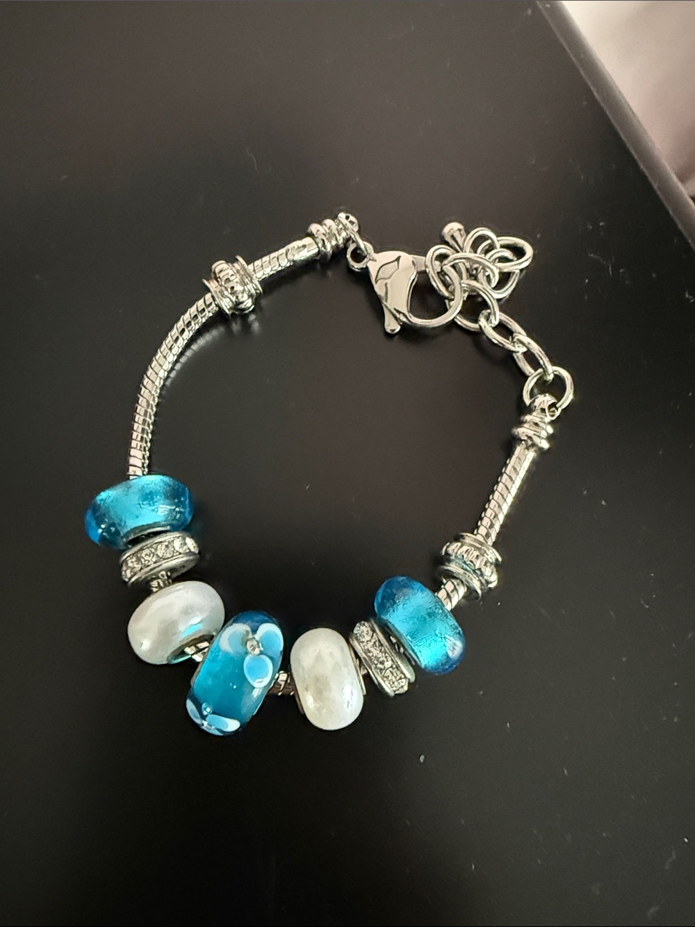 Silver Charm Bracelet with Blue Glass and White Bead Accents